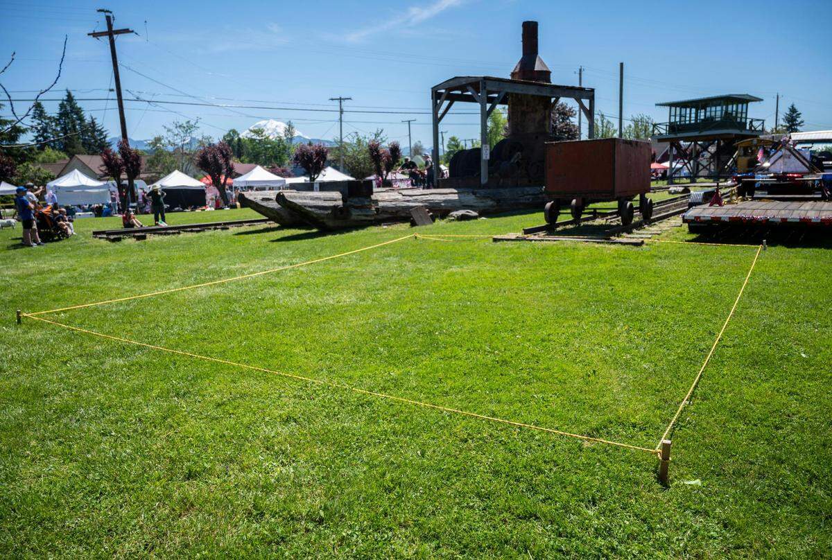 Wooden stakes and rope were placed in the grass by Foothills Rails-to-Trails Coalition committee member Milt Tremblay to show where a future pavilion in honor of Dr. Douglas Tait will sit once it’s built behind Wally’s Drive-In in Buckley, Wash. on Saturday, June 25, 2022.