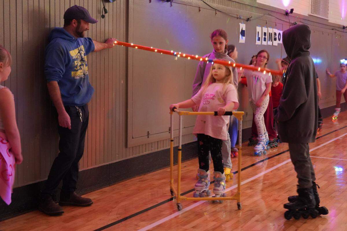 Skaters play limbo during Skate Night at the Key Peninsula Civic Center in Vaughn, Wash., Friday, Feb. 13, 2026.