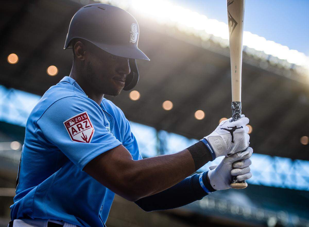 Mariners’ Kyle Lewis warms up on deck before his at-bat. The Seattle Mariners played the San Diego Padres in a exhibition baseball game at T-Mobile Park in Seattle, Wash., on Tuesday, March 26, 2019. 