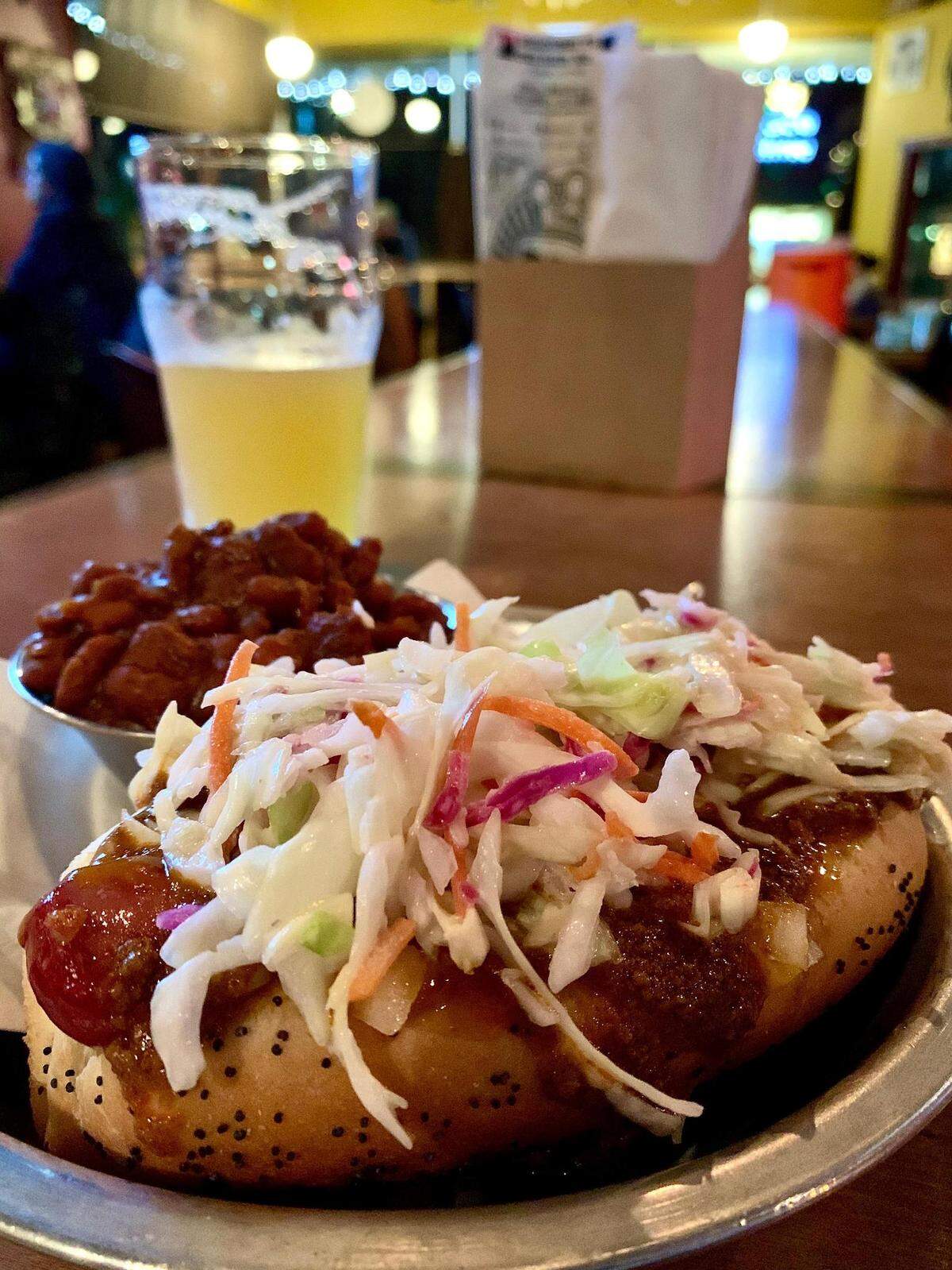 The Destiny City Dog at The Red Hot in Tacoma adds coleslaw and chili. The renowned beer bar also makes some mean vegan baked beans.