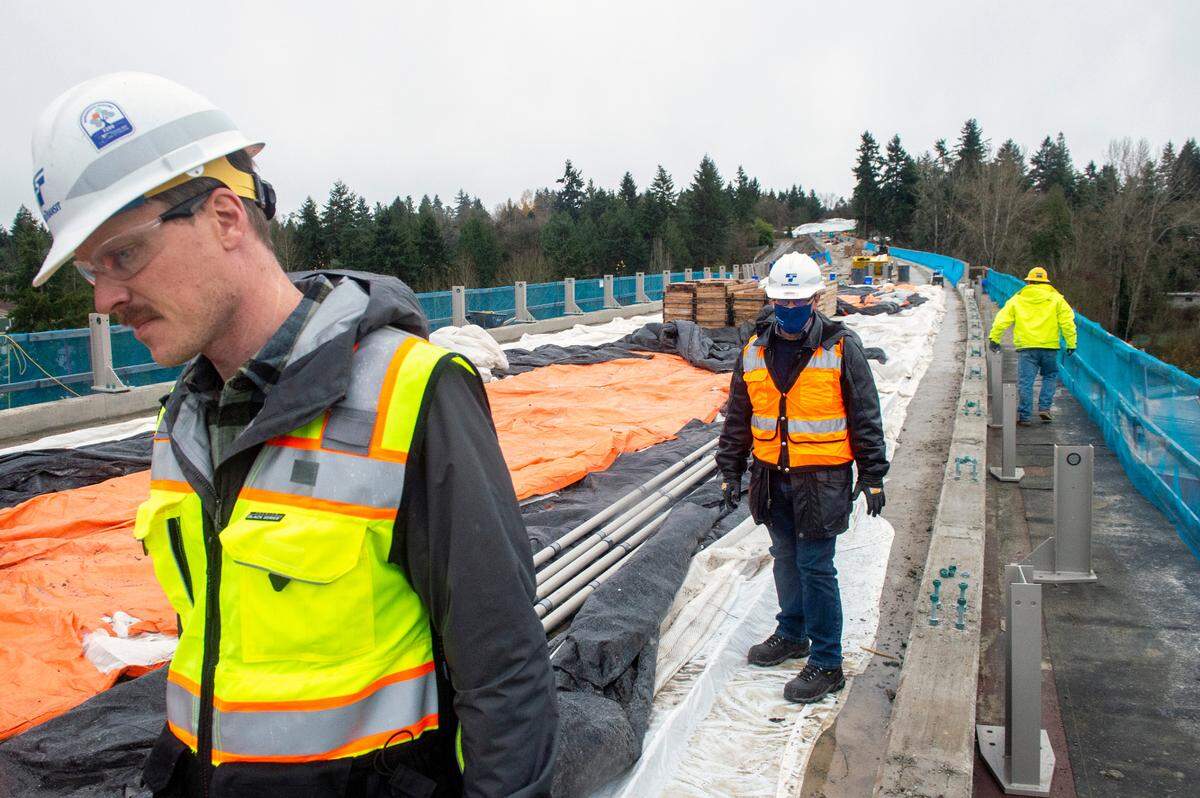 Nathan Monroe, a Sound Transit construction manager, walks along the elevated tracks on the far north section of the link extension less than a mile from Angle Lake State in SeaTac.