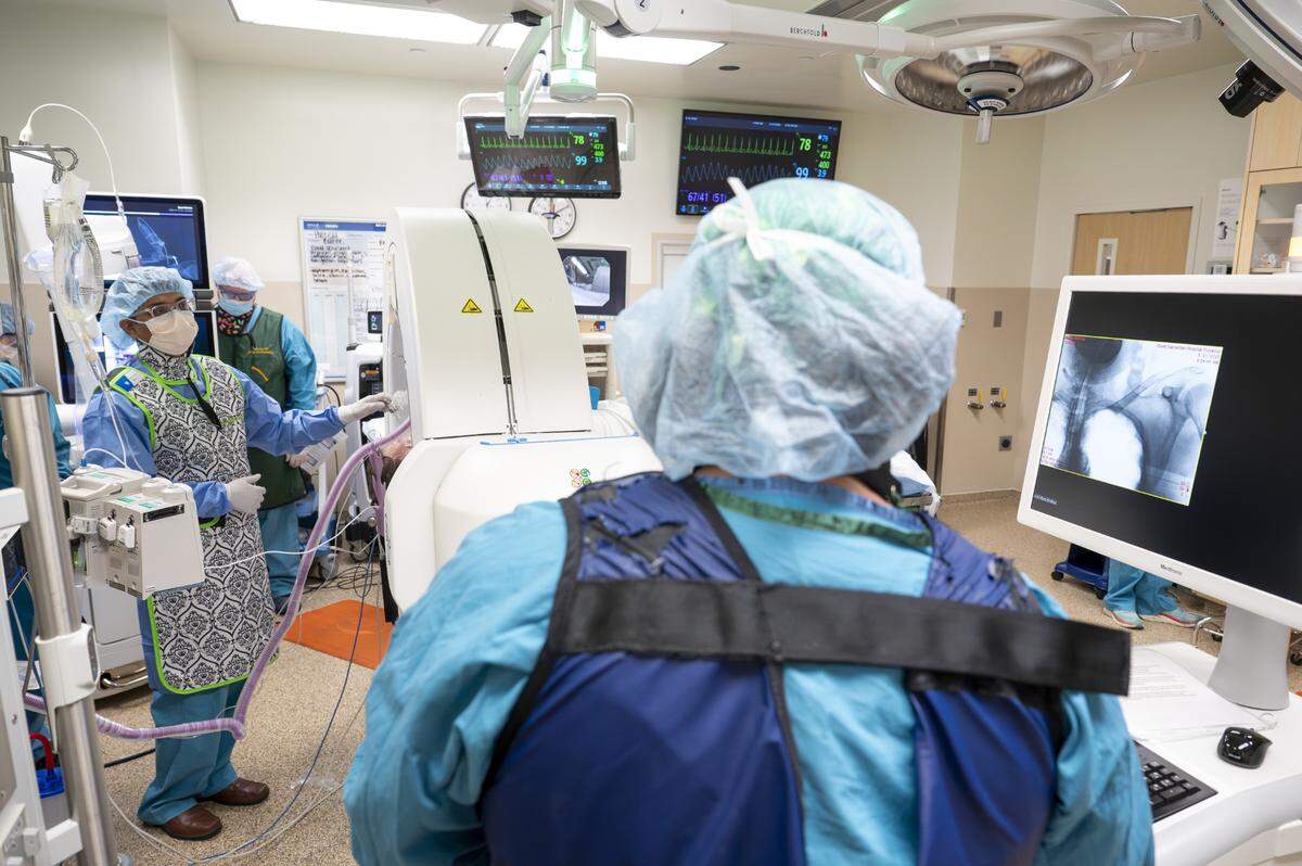 Abhishek Biswas, left, a pulmonologist with Multicare Health, utilizes X-ray imaging, center and right, to prepare for a lung biopsy using the DaVinci ION robotic surgery system on Wednesday, May 21, 2025, at Good Samaritan Hospital in Puyallup, Wash.