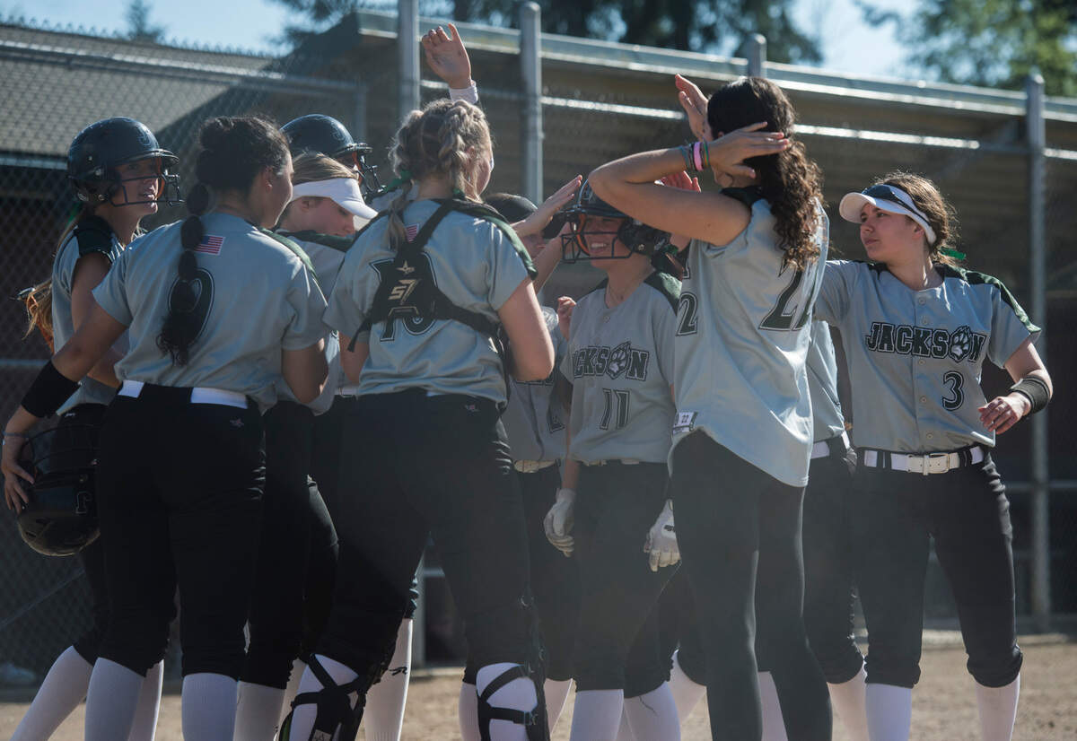 Jackson shortstop starter Rachel Sysum (11) celebrates with teammates after hitting a leadoff home run in the fourth inning of a nonleague softball game against Bonney Lake on Friday, April 28, 2023 at Jackson High School in Mill Creek, Wash.