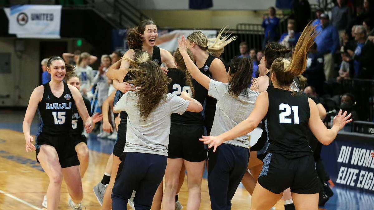 Western Washington players celebrate their win over top-seeded North Georgia in a NCAA Division II national semifinals game on Thursday, March 24, 2022 in Birmingham, Ala.