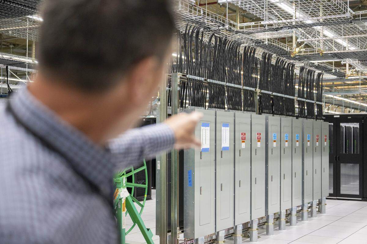 Dave Vranizan, Centeris vice president of leasing and operations, points to circuit breakers on the floor of the SH1 Data Center on Friday, Feb. 13, 2026, in Puyallup, Wash.