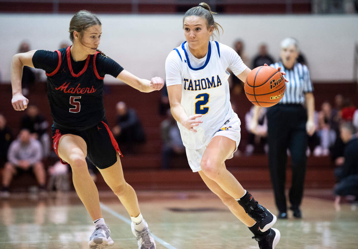 Tahoma’s guard Hope Hassmann (2) drives down the court as Camas’s guard Parker Mairs (5) tries to guard her during game at the Puget Sound Holiday Classic Tournament in the Memorial Field-house in Tacoma, Wash. on Jan. 16, 2023.