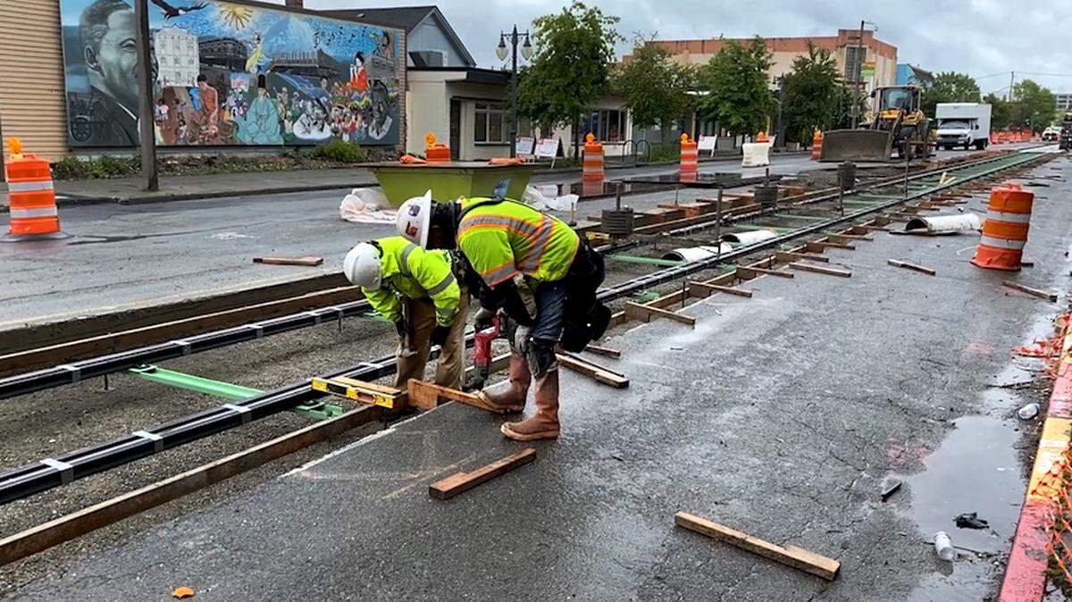 Construction crew members work on track installed on Martin Luther King Jr. Way in Tacoma on June 9, 2020. Sound Transit’s 2.4 mile extension of Tacoma’s Link light rail will run from Commerce Street to the Hilltop Neighborhood.