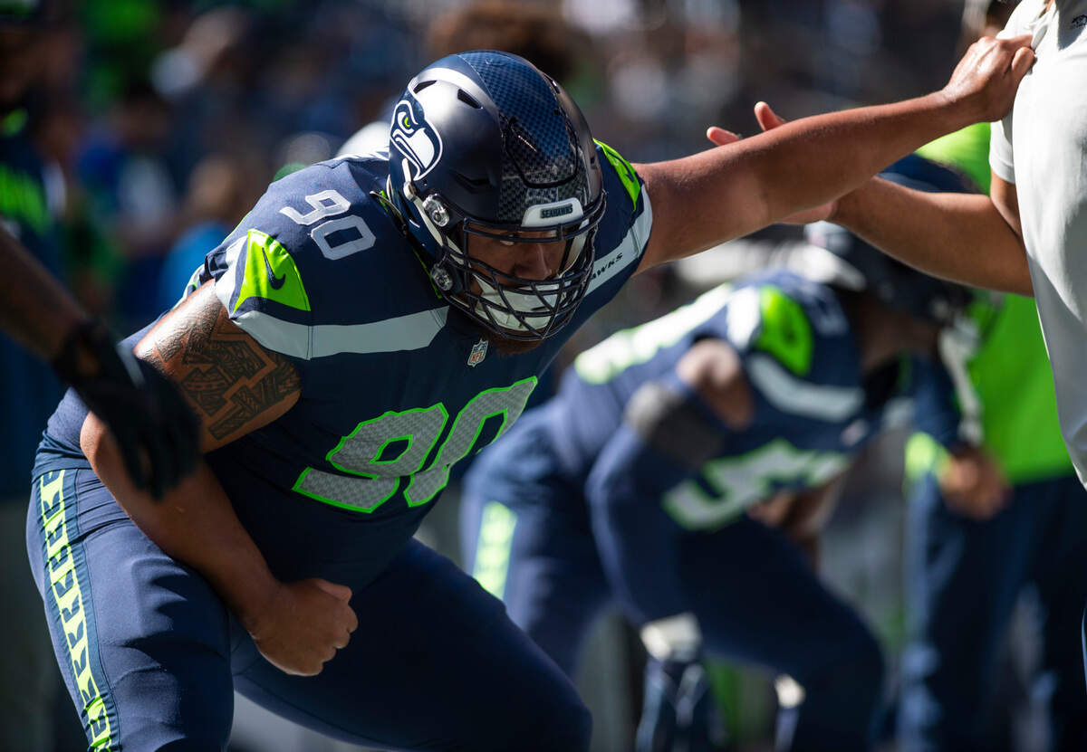 Seattle Seahawks defensive tackle Bryan Mone (90) practices a drill as he warms up before the start of an NFL game at Lumen Field in Seattle, Wash. on Sept. 25, 2022.