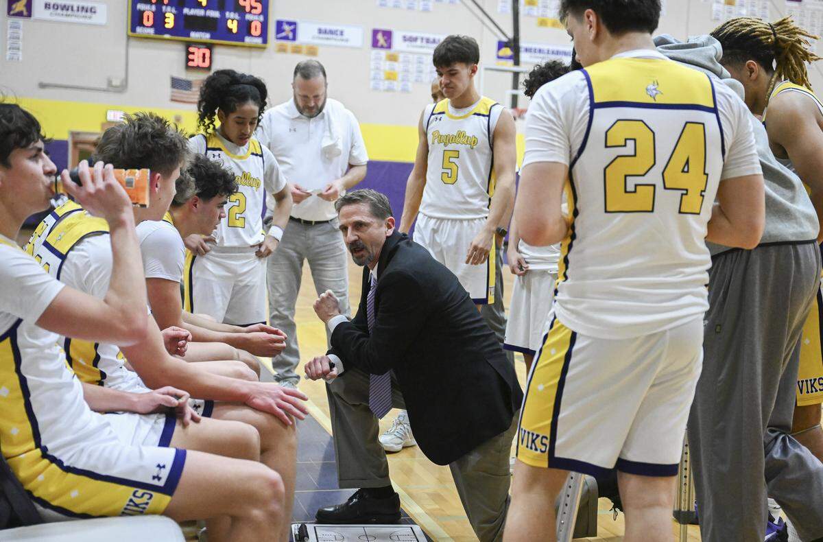 Puyallup head coach Kevin Olson huddles with players during a game against Olympia on Thursday, Jan. 15, 2026, in Puyallup, Wash.