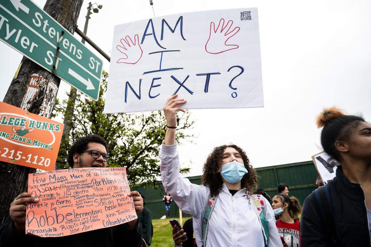 Foss High School students protest against gun violence after conducting a school walkout before their last class of the day on on the corner of South 19th Street and South Tyler Street outside of the Heidelberg Sports Complex on Thursday, May 26, 2022 in Tacoma, Wash.