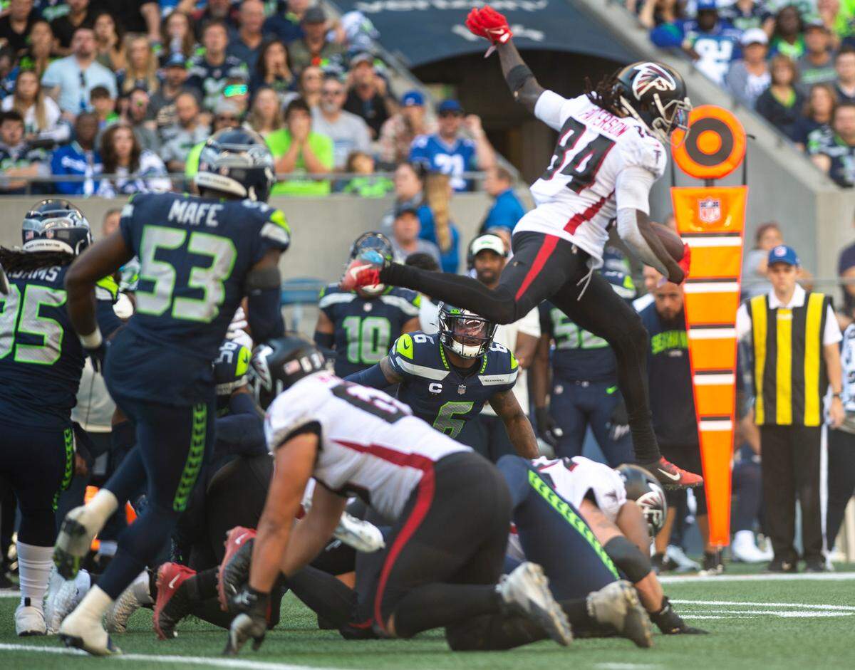 Seattle Seahawks safety Quandre Diggs (6) watches as Atlanta Falcons running back Cordarrelle Patterson (84) jumps over a group of players while running down the field in the fourth quarter of an NFL game at Lumen Field in Seattle on Sept. 25, 2022. The Seahawks lost to the Falcons 23-27.