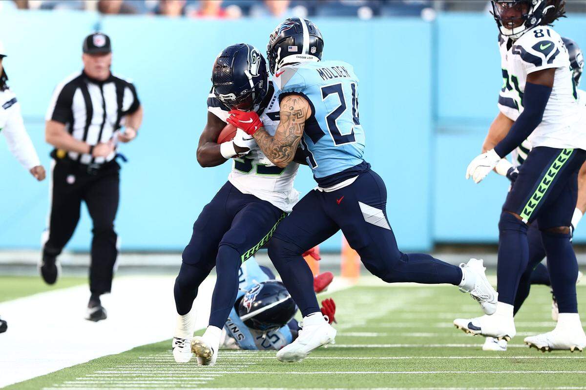 Aug 17, 2024; Nashville, Tennessee, USA; Seattle Seahawks wide receiver Dee Williams (33) is pushed out of bounds by Tennessee Titans cornerback Elijah Molden (24) in the first quarter of the game at Nissan Stadium. Mandatory Credit: Casey Gower-USA TODAY Sports