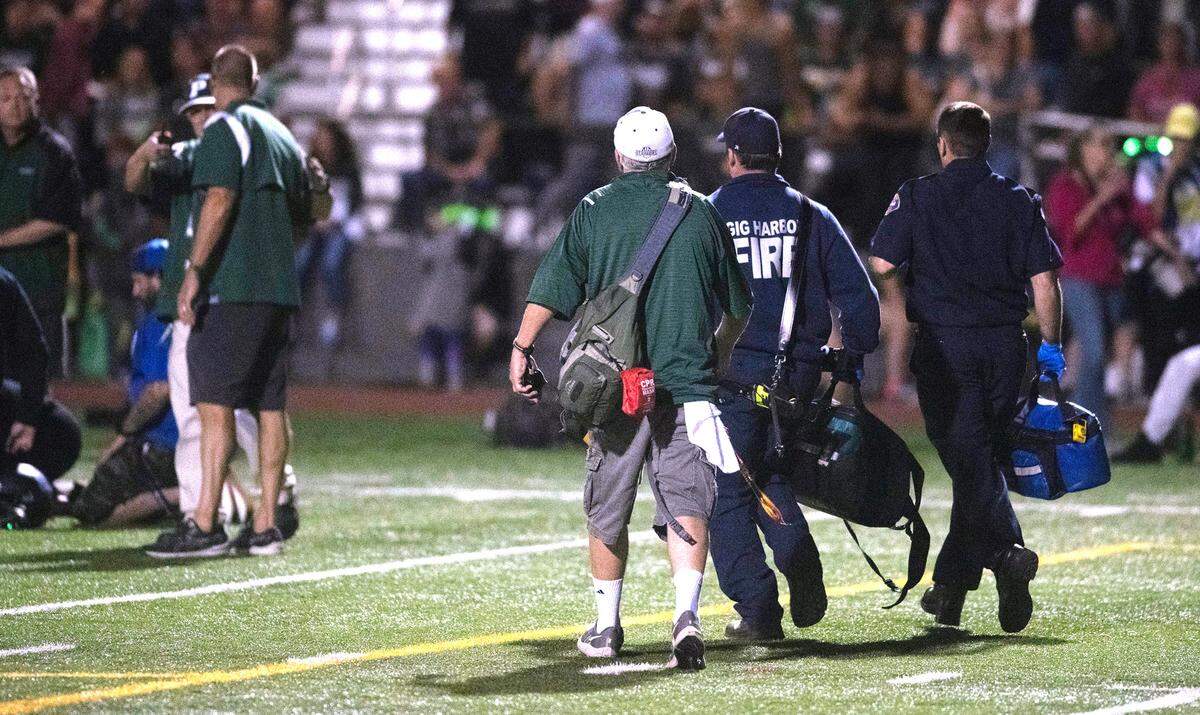 Paramedics arrive on the field at 8 p.m. during the Fish Bowl crosstown rivalry football game at Roy Anderson Field in Purdy, Washington, on Sept. 15, 2023. Gig Harbor won the game, 21-20.