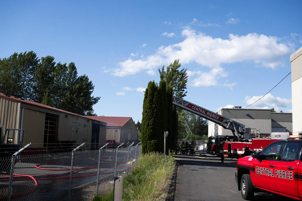 Central Pierce Fire and Rescue and other crews asses a commercial fire near the 2100 block of Inter Ave., on Monday, May 12, 2025, in Puyallup, Wash.