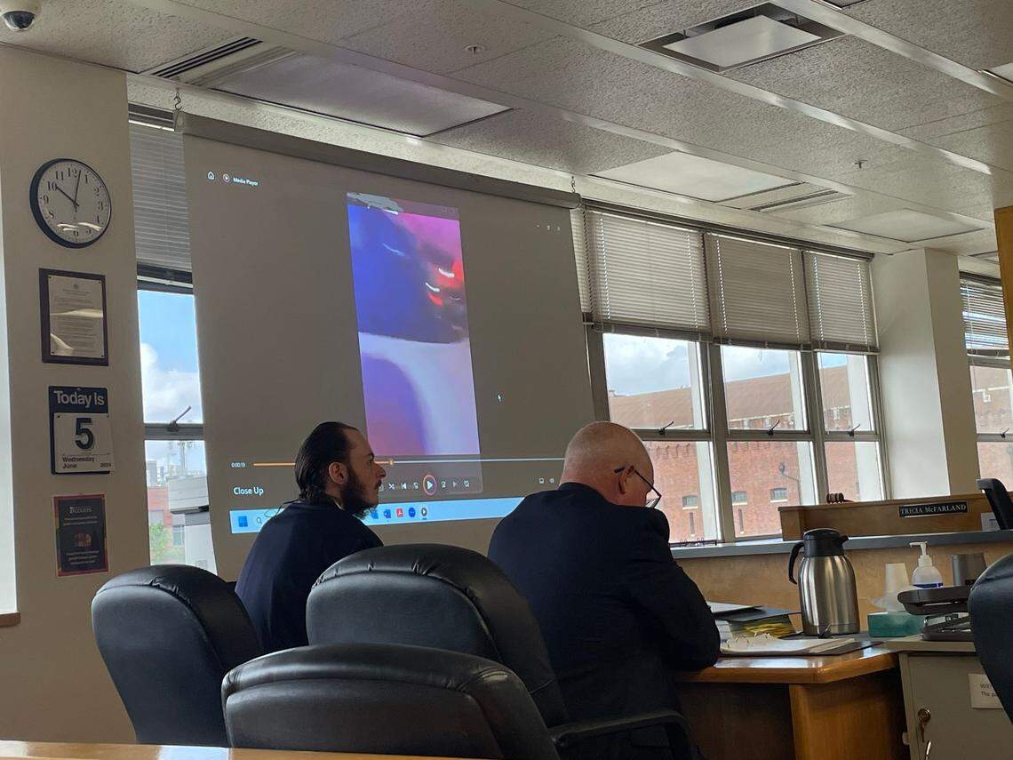 Anthony Edward Huff-McKay (left) listens while prosecutors deliver closing arguments to the jury in his trial for charges of unlawful imprisonment, second-degree malicious mischief and obstructing a law enforcement officer. Huff-McKay, 25, is accused of directing a crowd to surround two Tacoma Police Department patrol cars after officers responded to a street racing event Jan. 23, 2021 at Pacific Avenue and South 9th Street.
