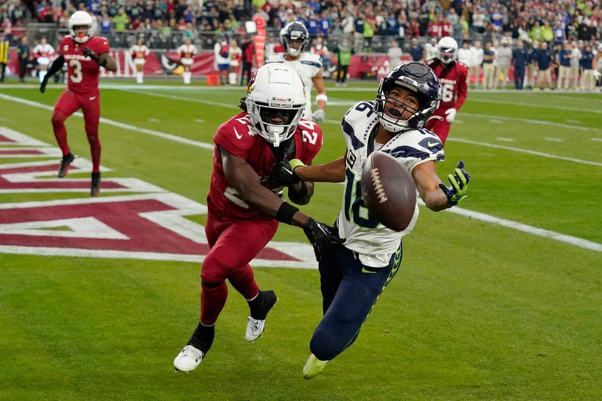 Seattle Seahawks wide receiver Tyler Lockett (16) can’t catch a pass in the end zone as he is defended by Arizona Cardinals cornerback Starling Thomas V (24) in the first half of an NFL football game Sunday, Jan. 7, 2024, in Glendale, Ariz. (AP Photo/Ross D. Franklin)