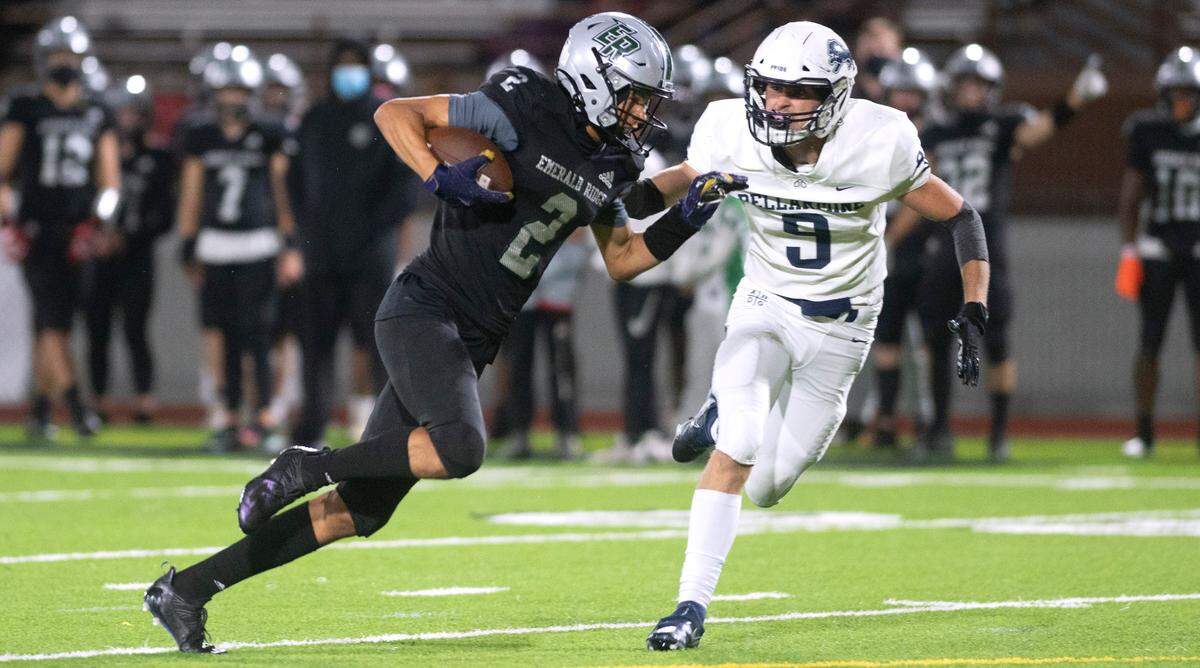 Emerald Ridge wide receiver Denzel Boston powers upfield past Bellarmine Prep defensive back Ty Faker for a touchdown reception during Thursday night’s 4A SPSL football game at Sparks Stadium in Puyallup, Washington, on Sept. 30, 2021.