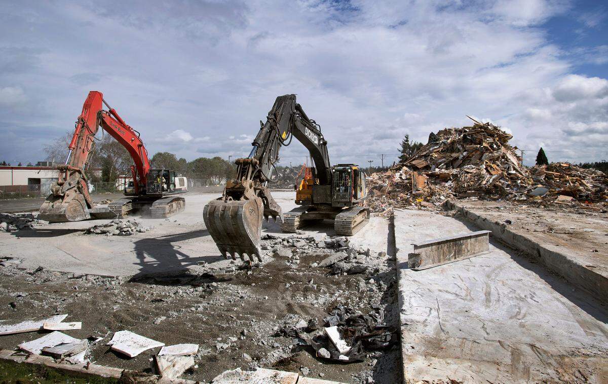 Workers continue the demolition of the former Narrows Bowl in University Place, Washington, on Tuesday, March 15, 2022.