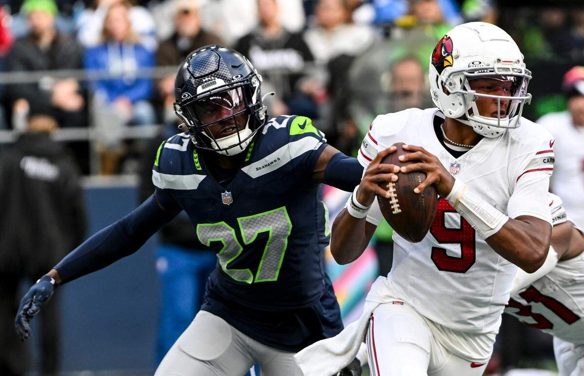 Seattle Seahawks cornerback Riq Woolen (27) chases down Arizona Cardinals quarterback Joshua Dobbs (9) during the fourth quarter of the game at Lumen Field, Sunday, Oct. 22, 2023, in Seattle, Wash.
