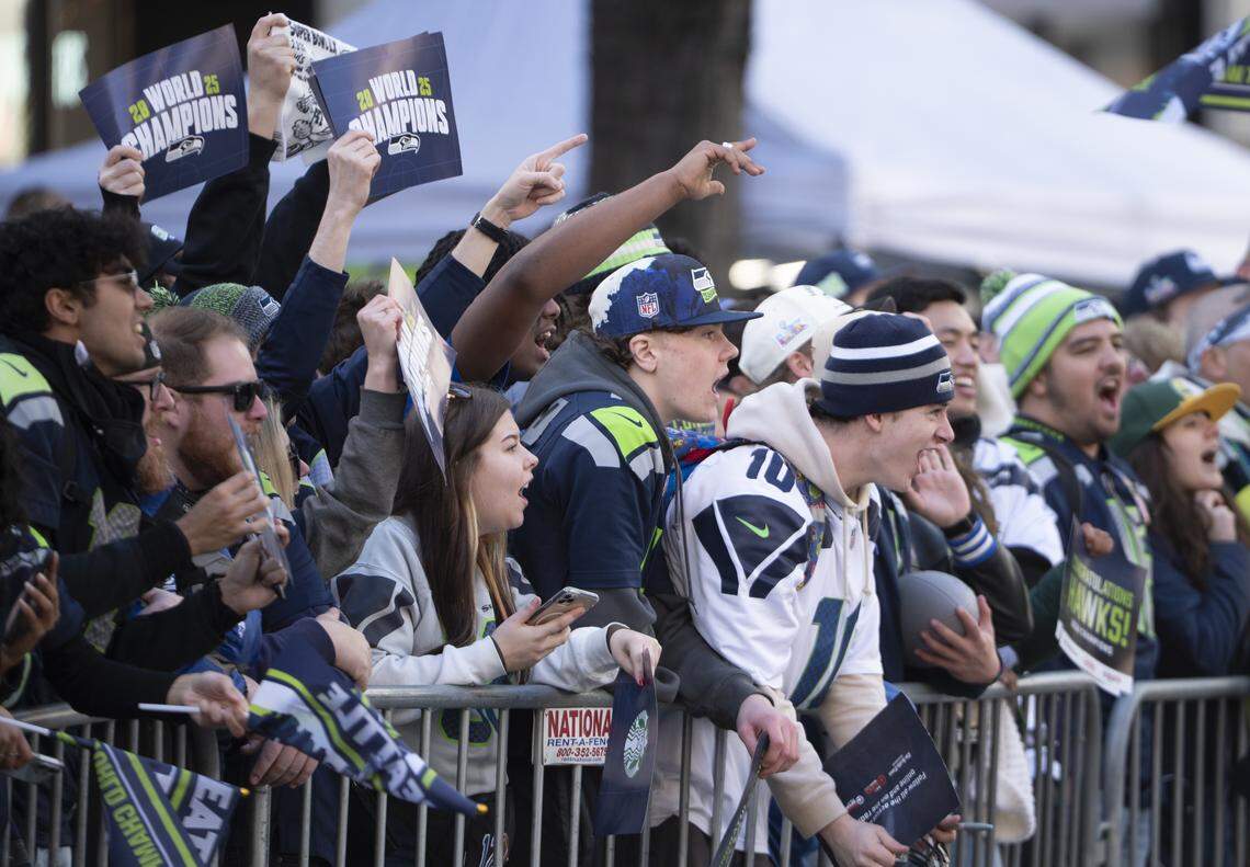 Fans cheer from along the Super Bowl parade route on Wednesday, Feb. 11, 2026, in downtown Seattle.