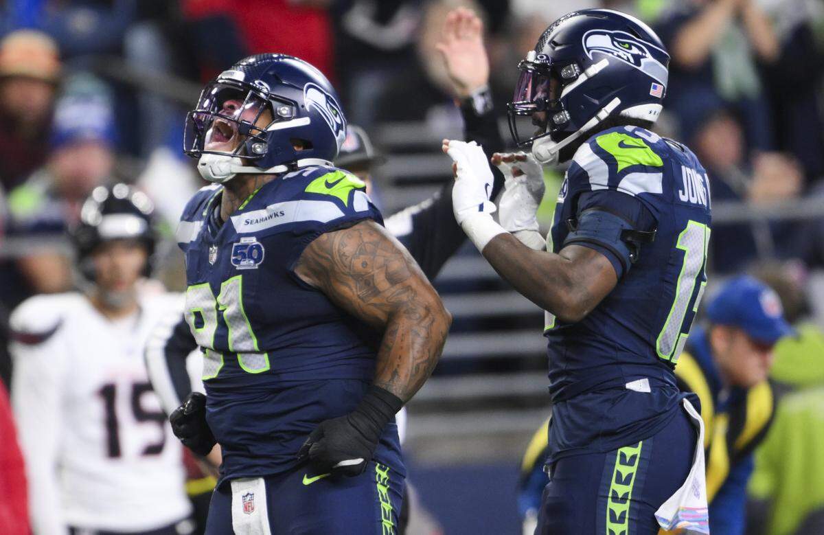 Seattle Seahawks defensive tackle Byron Murphy II (91) reacts to a tackle on Houston Texans running back Nick Chubb (21) for a 5-yard loss during the second quarter of the game at Lumen Field, on Monday, Oct. 20, 2025, in Seattle.
