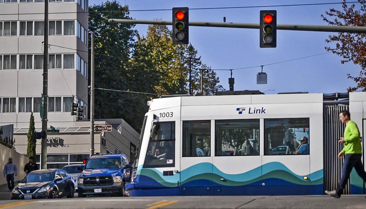 A LINK streetcar passes South 13th and Commerce streets in downtown Tacoma. The red light for those on South 13th street lasts 43 seconds after the streetcar passes.