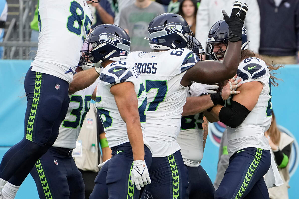 Seattle Seahawks tight end Colby Parkinson, right, is congratulated by teammates after scoring during the second half of an NFL football game against the Tennessee Titans on Sunday, Dec. 24, 2023, in Nashville, Tenn. (AP Photo/George Walker IV)