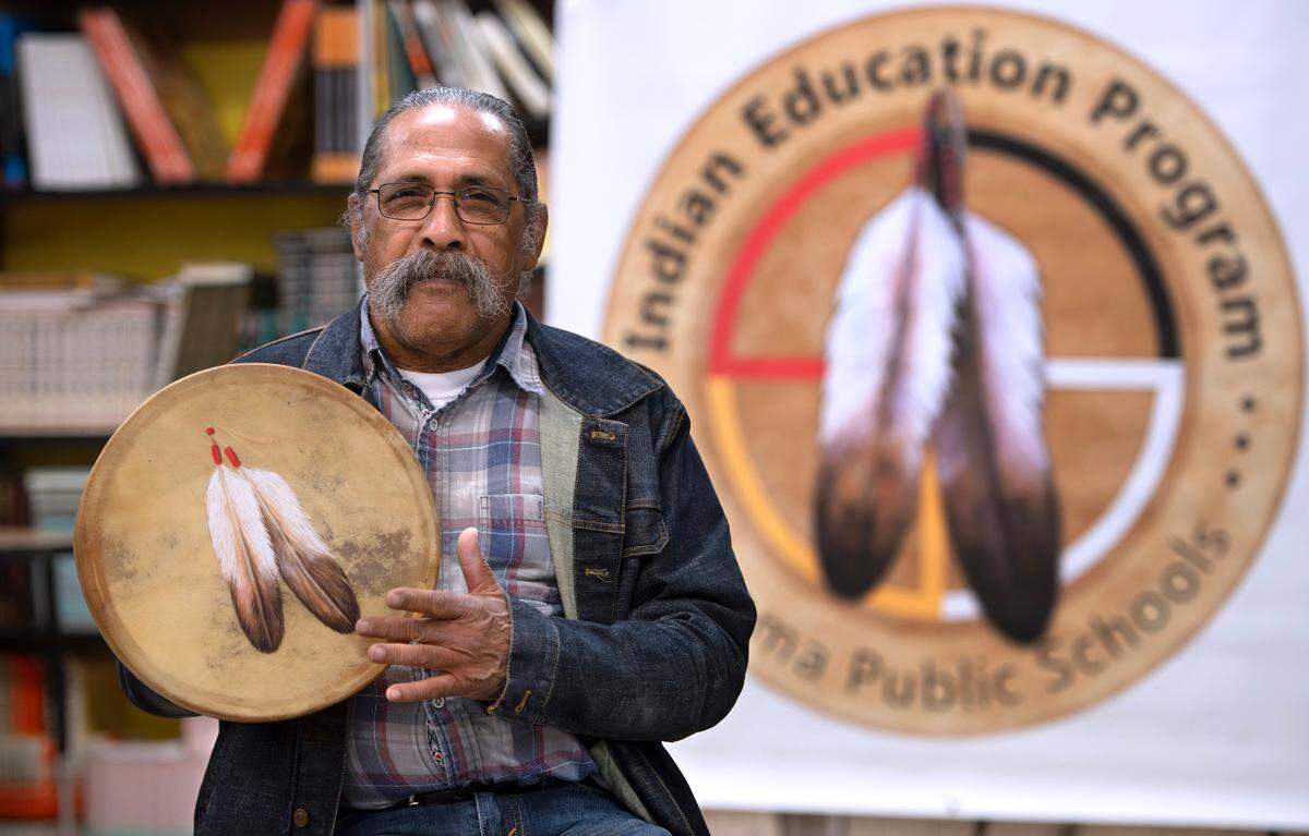 Tribal drum artist George Zantua holds one of his painted drums in a classroom at the Madison Complex in Tacoma on Thursday, May 2, 2024.