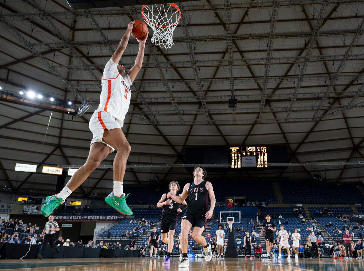 Eastside Catholic’s Jacob Cofie (5) goes up for a dunk during the semifinals game of the Class 3A state tournament at the Tacoma Dome, on Friday, March 1, 2024, in Tacoma, Wash.
