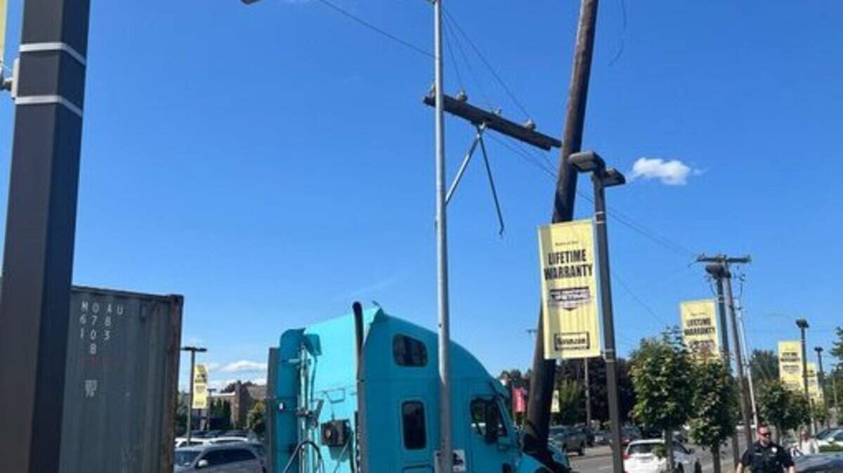 A semi-truck collision in Puyallup downed power poles and reduced traffic to one lane on eastbound River Road turning north to North Meridian on Thursday, May 22, 2025, in Puyallup, Wash.