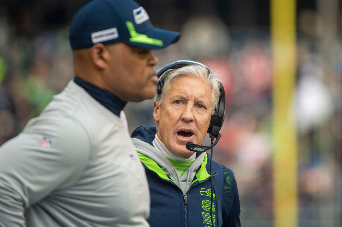 Seattle Seahawks head coach Pete Carroll talks to defensive coordinator Ken Norton Jr. after a 49er touchdown during the first quarter of an NFL game on Sunday at Lumen Field in Seattle.