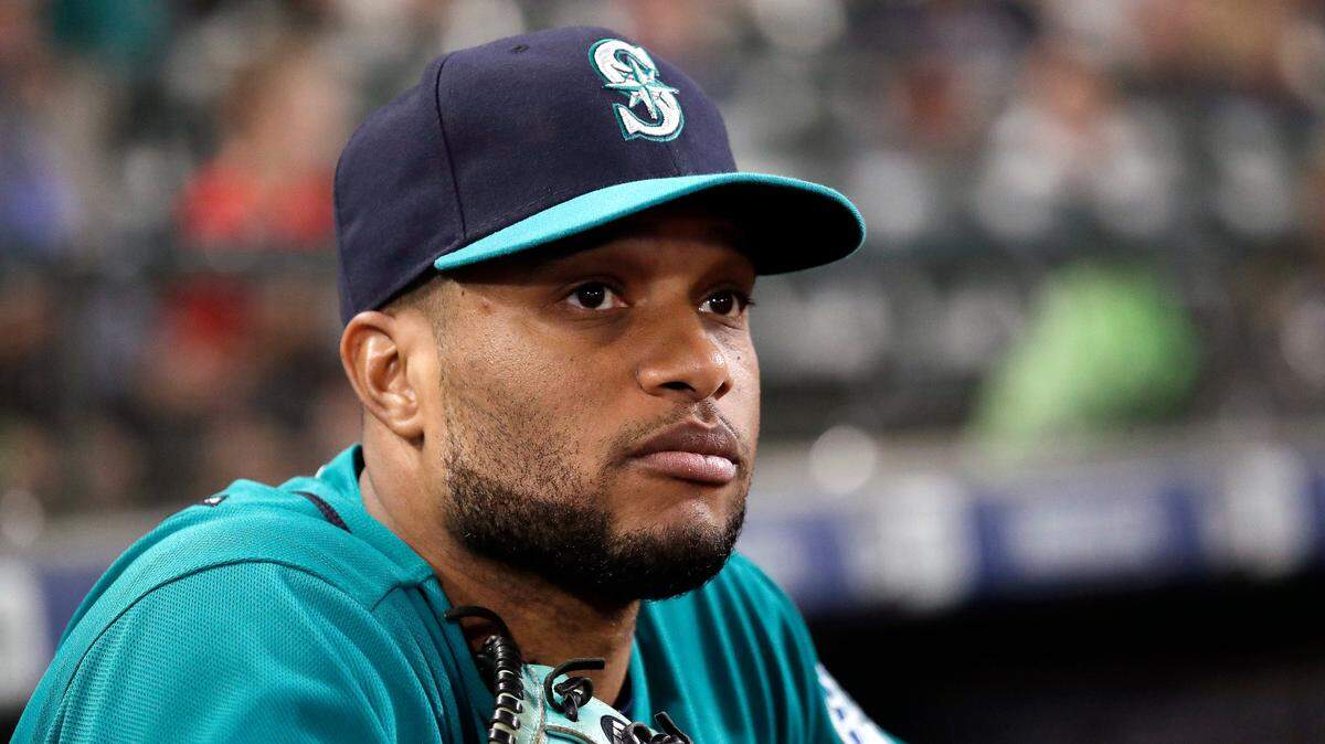 Seattle Mariners second baseman Robinson Cano looks on from the dugout before a baseball game against the Texas Rangers Friday, Sept. 28, 2018, in Seattle. (AP Photo/Elaine Thompson)