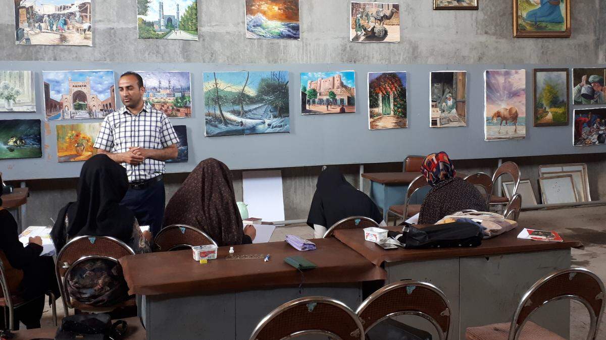 Afghanistan Artist, Abdul, standing in his art studio.