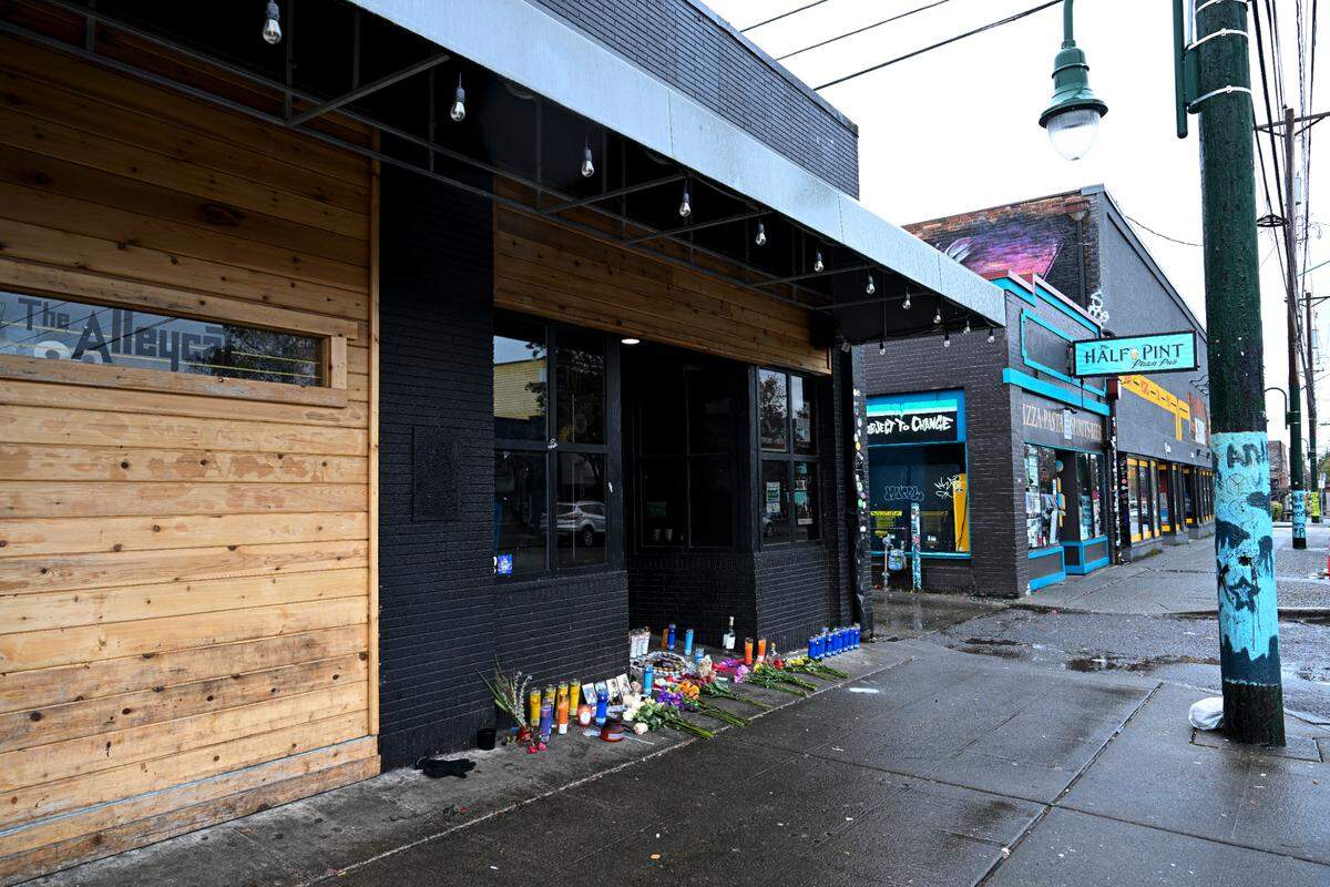 A candle memorial is set up at the site of a shooting that occurred on Sunday morning and left two dead and three injured, at The Alleycat on 6th Avenue, Monday, Nov. 6, 2023, in Tacoma.