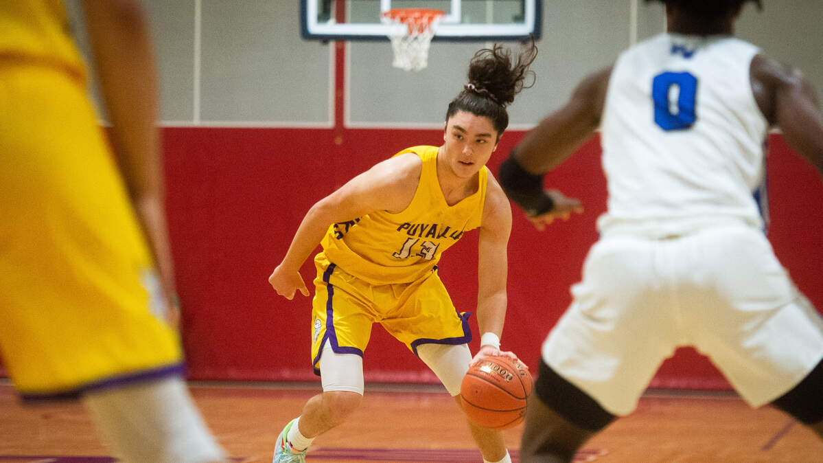 Puyallup’s Luke Holcomb looks to pass during the first quarter. Puyallup played Federal Way in a basketball game at Wilson High School in Tacoma, Wash., on Friday, Dec. 27, 2019.