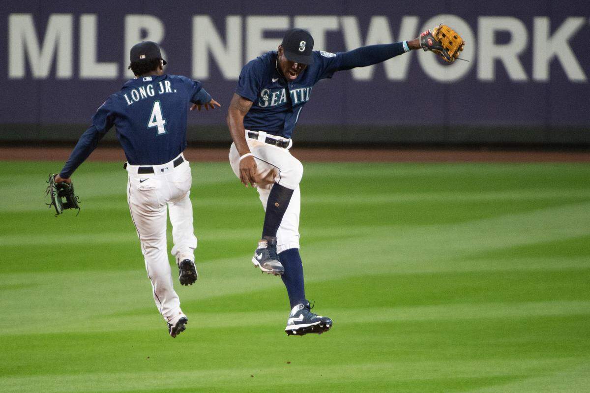 Seattle Mariners second baseman Shed Long Jr. (4) and Seattle Mariners right fielder Kyle Lewis (1) celebrate the Mariners’ win. The Seattle Mariners played the Los Angeles Dodgers in a Major League Baseball game at T-Mobile Park in Seattle, Wash., on Wednesday, Aug. 19, 2020.