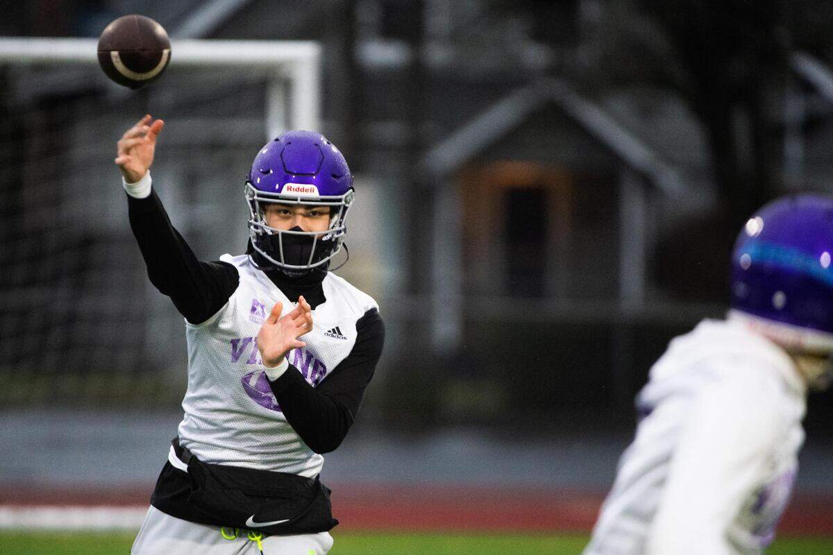 Quarterback Luke Holcomb throws a pass during drills. The Puyallup Vikings held their first football practice at Sparks Stadium in Puyallup, Wash., on Monday, Feb. 1, 2021.
