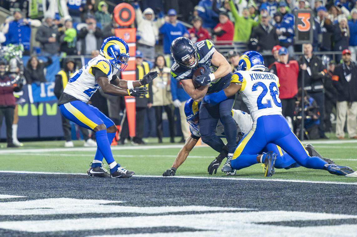 Seattle Seahawks wide receiver Cooper Kupp (10) pushes against Rams defenders, including Rams safety Kamren Kinchens (26), during the NFC Championship game at Lumen Field, on Sunday, Jan. 25, 2026, in Seattle.