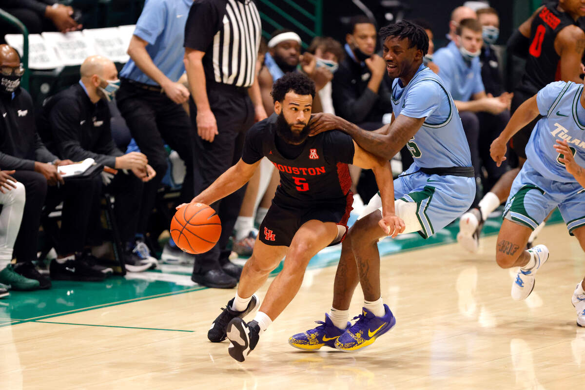 Houston guard Cameron Tyson (5) and Tulane guard Jaylen Forbes (25) in the first half of an NCAA college basketball game in New Orleans, Thursday, Jan. 28, 2021. (AP Photo/Tyler Kaufman)