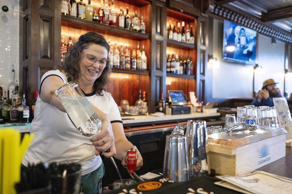 Bartender Gigi Zueger prepares drinks at Terry's Bar and Grill on Wednesday, Jan. 7, 2026, in Tacoma, Wash.