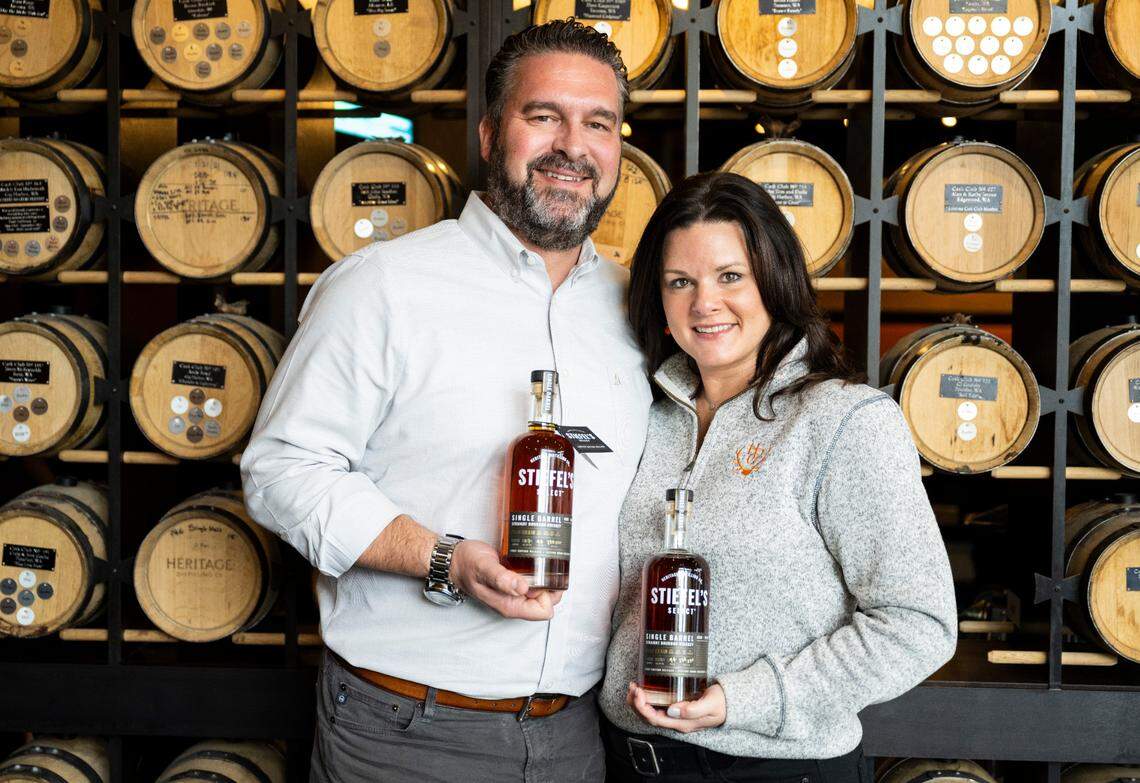 Heritage Distilling Co. founders Justin and Jennifer Stiefel pose for a portrait with bottles of their first line of single-barrel whiskey at their flagship tasting room in Gig Harbor, Wash. on Oct. 26, 2022.