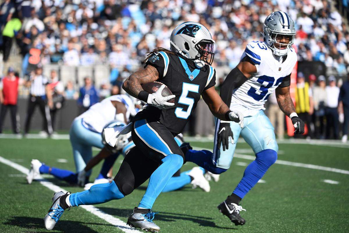 Nov 19, 2023; Charlotte, North Carolina, USA;  Carolina Panthers wide receiver Laviska Shenault Jr. (5) with the ball as Dallas Cowboys wide receiver Jalen Brooks (83) defends in the second quarter at Bank of America Stadium. Mandatory Credit: Bob Donnan-USA TODAY Sports