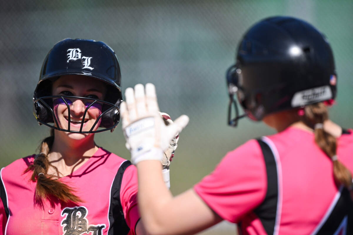 Bonney Lake’s Jess Eaton and Kendall Thomas celebrate a run during the softball game against Lincoln at Bonney Lake High School, on Thursday, April 18, 2024, in Bonney Lake, Wash.
