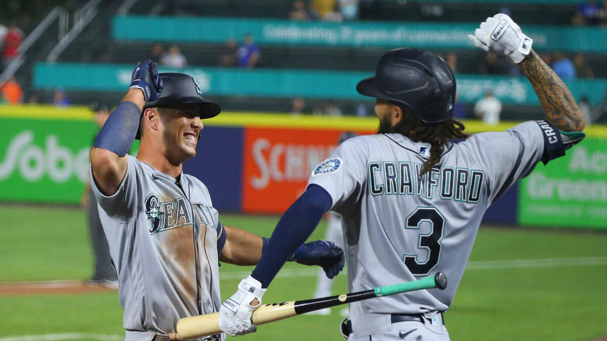 Seattle Mariners Dylan Moore, left, celebrates his three-run home run with J.P. Crawford during the tenth inning of a baseball game against the Toronto Blue Jays, Wednesday, June 30, 2021, in Buffalo, N.Y. (AP Photo/Jeffrey T. Barnes)