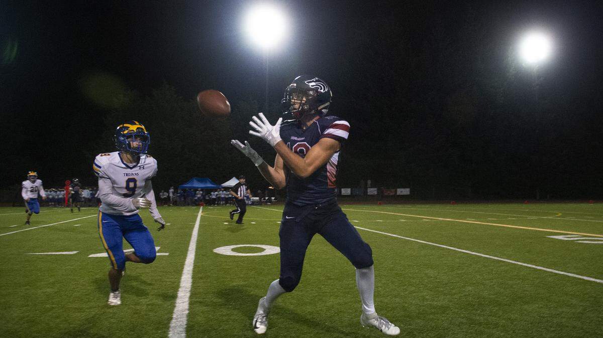 Black Hills wide receiver Nick Bovenkamp pulls in a pass in front of Fife defensive back Elias Faitala during Friday night’s football game at Tumwater District Stadium on Sept. 13, 2019.