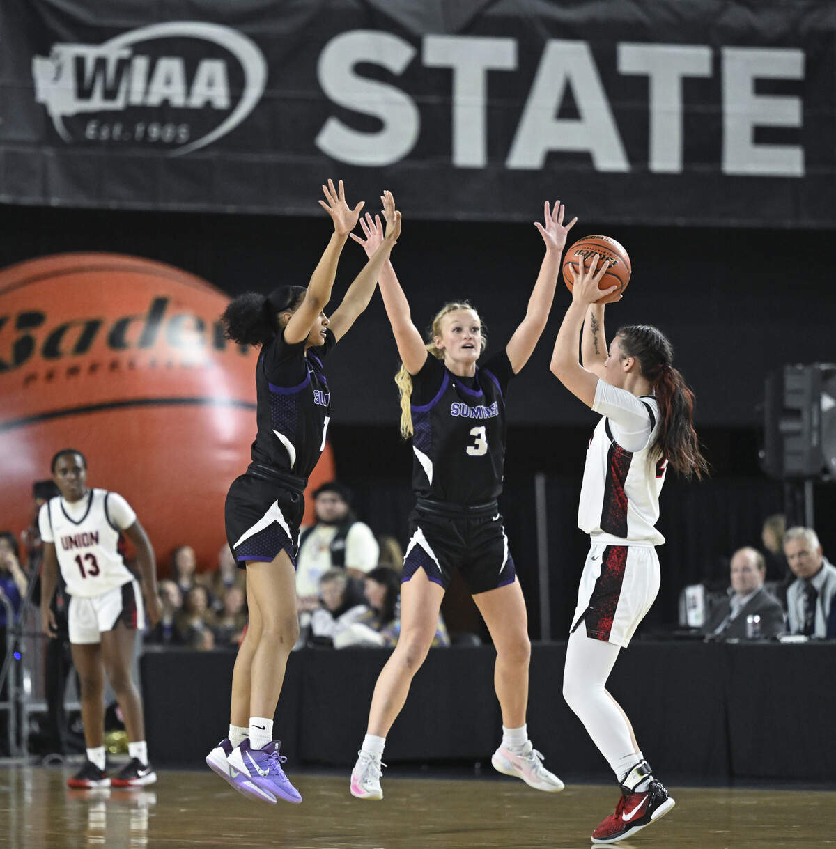 Sumner guard Meela Isabell (1) and Sumner guard Kessa Nohr (3) guard Union point guard Brooklynn Haywood (23) during the quarterfinal round of the 4A State Tournament at the Tacoma Dome, on Thursday, March 5, 2026, in Tacoma, Wash.