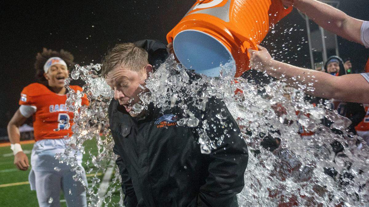 Graham Kapowsin head coach Eric Kurle is doused with water in the final minute of the fourth quarter as the Eagles begin to celebrate their 44-7 win over Lake Stevens in the State 4A championship game on Saturday afternoon at Mount Tahoma Stadium in Tacoma.