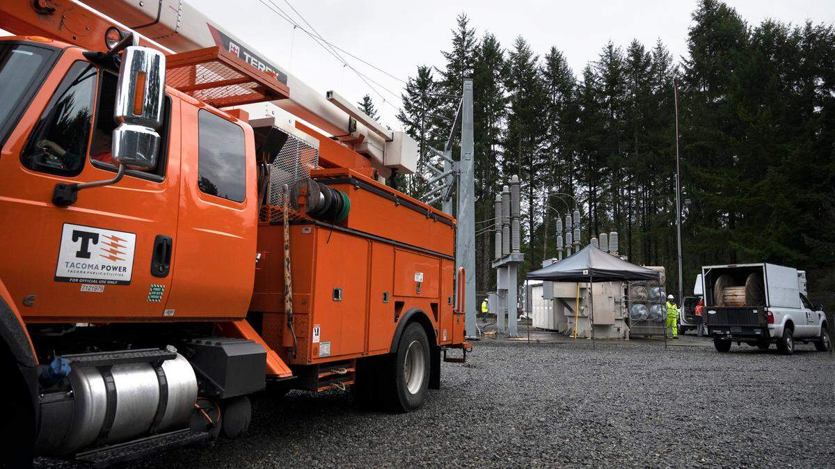 Tacoma Public Utilities workers switch the 224th Street East substation to a mobile transformer to restore power in Graham, Washington, on Monday, Dec. 26, 2022.