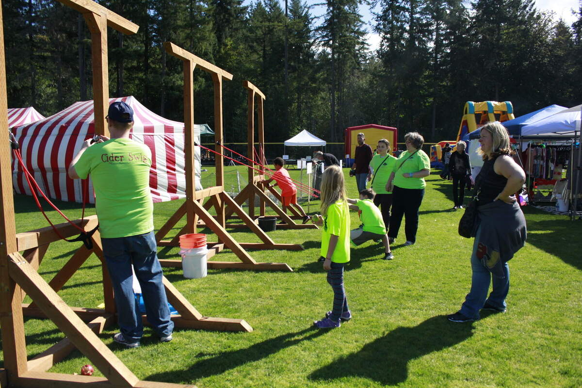 Volunteers with the Gig Harbor Cider Swig place frames for games at the annual event.