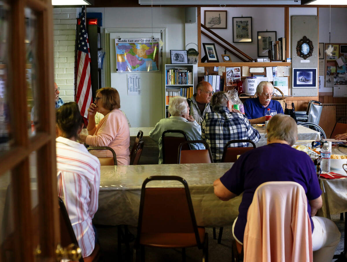 The congregation of Old St. Peter’s Church in Old Town Tacoma eat a meal together during their 146th anniversary celebration potluck picnic Aug. 10, 2019.